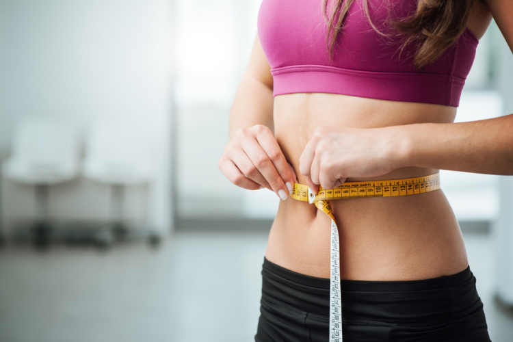 cannabis for weight loss woman measuring waist
